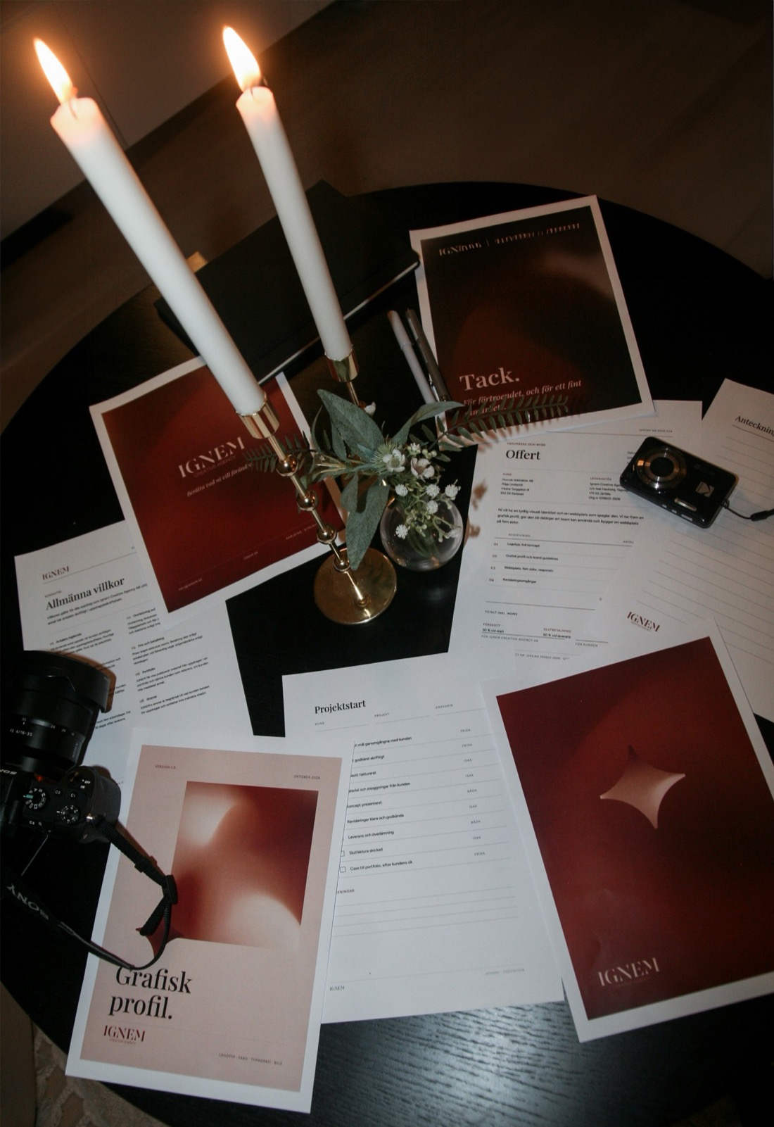 Brand guidelines, a quote and printed material on a table with candles