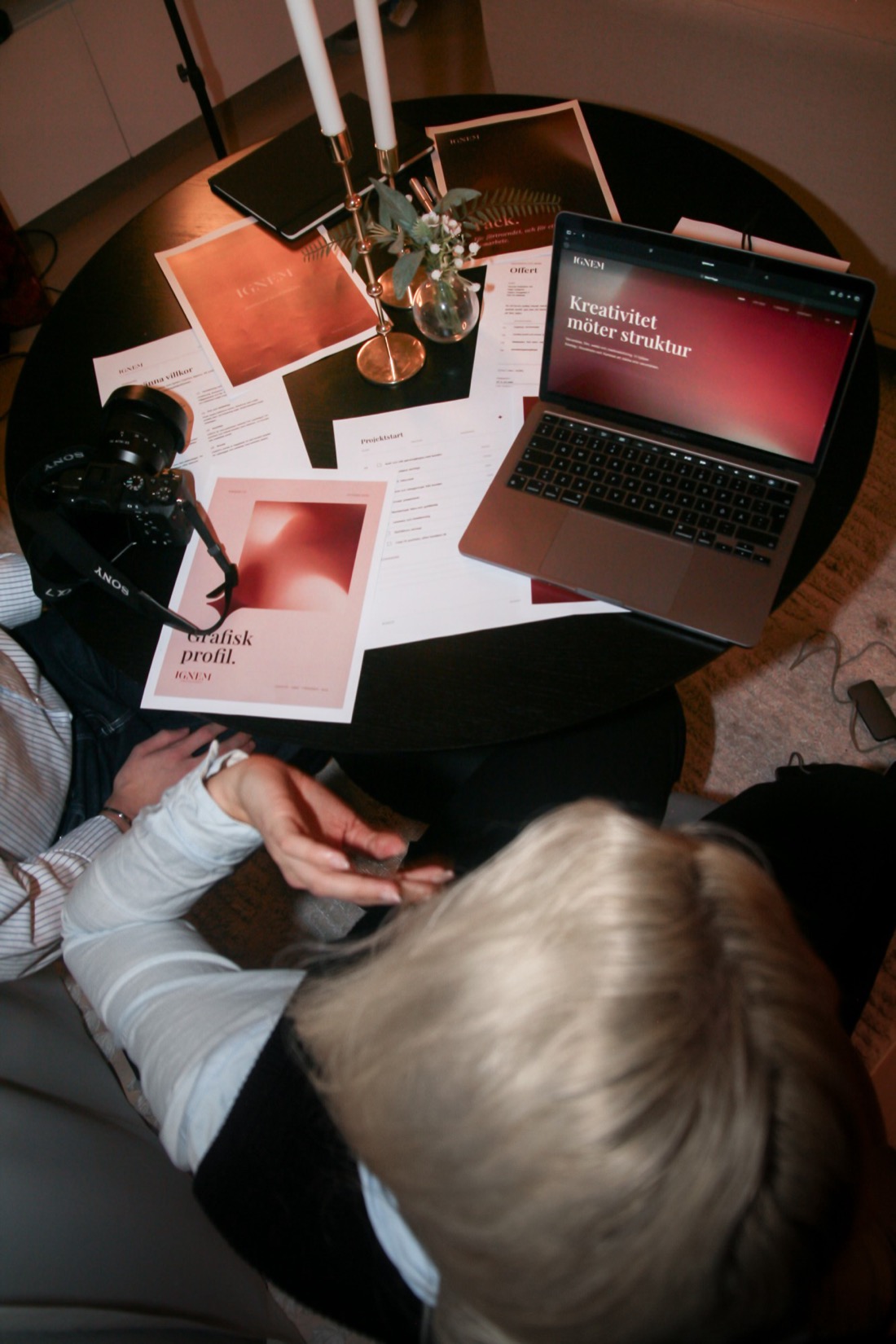 Ignem’s website on a laptop among printed material